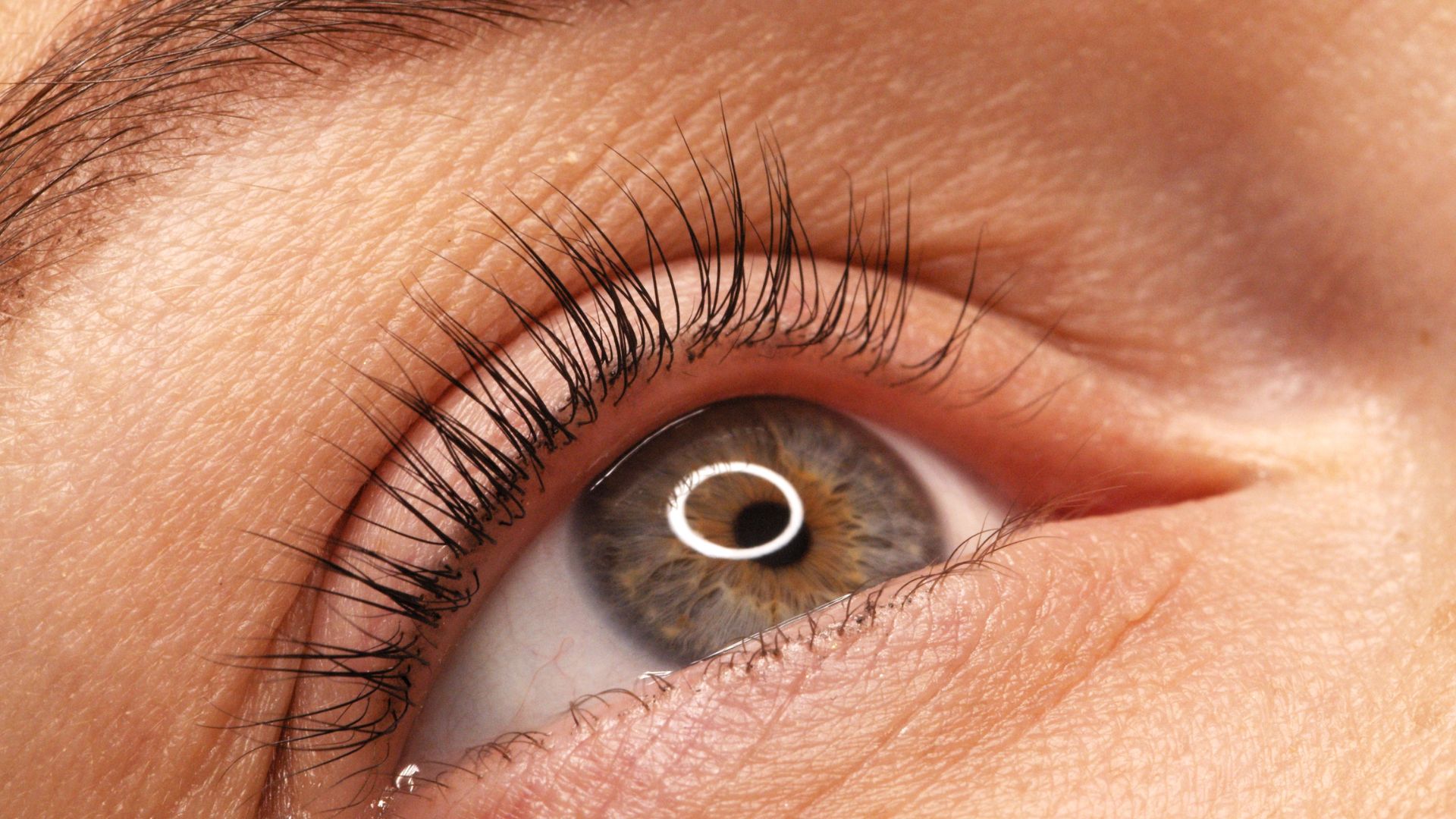 A close up of a person's eye with long lashes