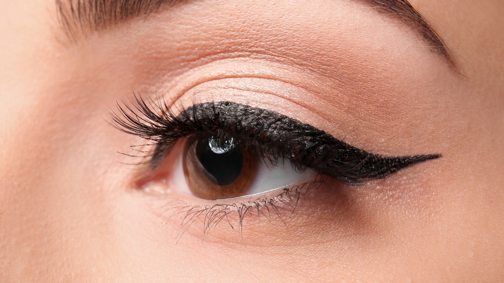 A close up of a woman's eye with long lashes